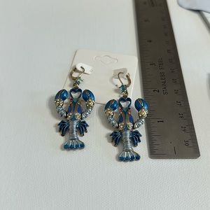 Betsey Johnson drop lobster earrings, multi blues. 1 pin eye stone missing